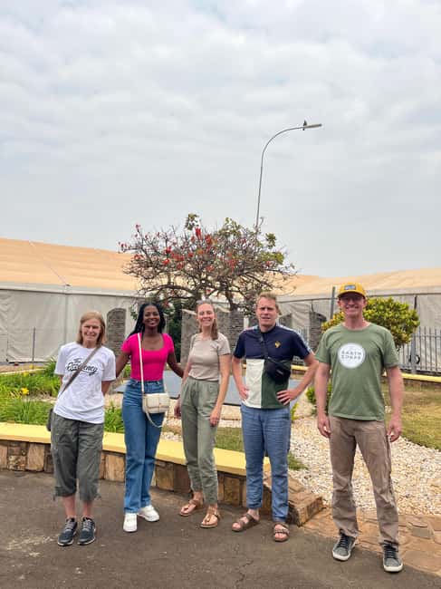 Kigali: Guided Art, History, and Food Tour with Moto Ride - The Kigali sign and central-city photographs